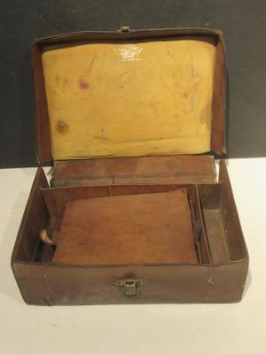 a brown suitcase with a yellow lining on the inside