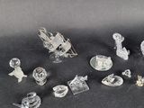 a lot of glass figurines on a black surface