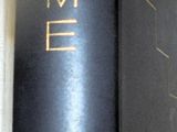 a black book with gold writing on it sitting on a table
