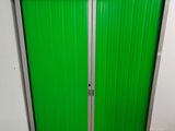 a green door that is open in a room