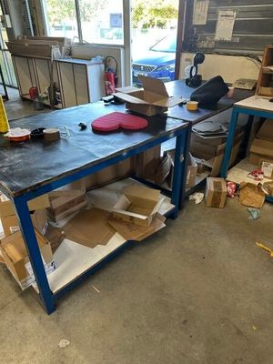 an image of a workbench in a garage with a lot of boxes on it
