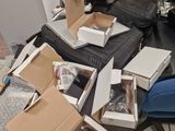 a pile of boxes on the floor next to a computer monitor