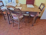 a wooden table with chairs and a book on top of it