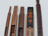 several different types of wood and metal tools sitting on a white surface