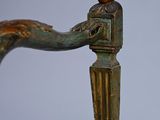 a close up of a chair with a bird on top of it
