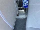 a cup holder in the back of a car with a can of soda in it
