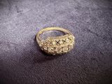 a close up of a gold ring on a black surface