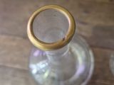 a glass bottle with a wooden lid on a wooden table