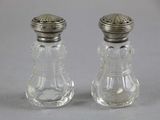 pair of clear glass salt and pepper shakers with silver tops