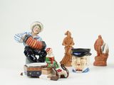 many figurines that are sitting on a white surface
