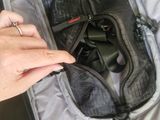 a person that is opening up a bag with a cell phone in it