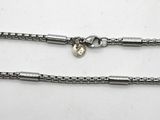 a close up of a chain with a heart on it