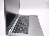 a silver laptop computer sitting on top of a white table