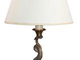 une lampe de table en laiton surmontée d'un abat-jour blanc
