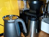 a coffee pot and a blender sitting on a kitchen counter