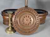 a copper pot and a brass candle holder on a white background