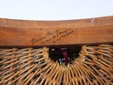 a wicker bag with writing on it sitting on a table