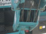 a close up of a blue truck with a chain attached to it