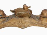 a bronze figurine of a duck and two eggs on a stand