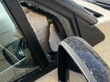 the side view mirror of a car with a broken window