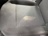 a dirty seat in a car with a dirty cloth on it