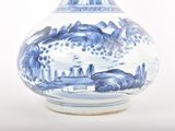a blue and white vase sitting on a white surface
