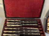 six knives in a case sitting on a table