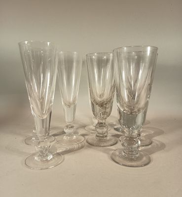 several empty wine glasses are lined up on a table