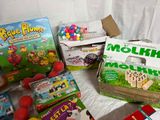 toys and games are laid out on a bed with a white sheet