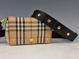 the small vintage check and leather belt bag is on display