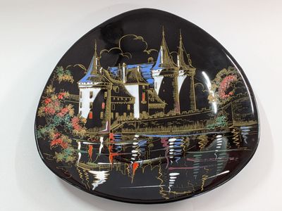 a black plate with a picture of a castle on it