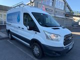 the white van is parked in the parking lot outside of the building