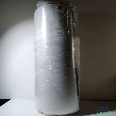 a white vase that is wrapped in plastic on a shelf