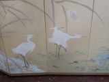 two birds painted on the side of a cabinet