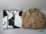 two sweaters sitting next to each other on a table