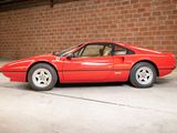 a red sports car parked in front of a brick wall