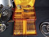 a wooden box with silverware in it on a table