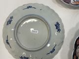 several plates and bowls are on a table with a white table cloth