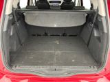 the back of a red car with its trunk open showing the cargo area