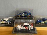 five different models of cars in display cases on a table