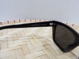 a pair of sunglasses sitting on top of a woven basket