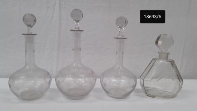 three glass bottles that are sitting next to each other