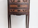 an old wooden chest of drawers sitting on top of a white floor