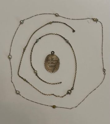 un gros plan d'un collier composé d'une pièce de monnaie suspendue à une chaîne