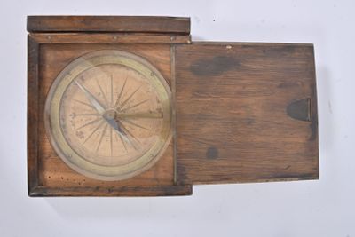 a small wooden box with a compass on top of it
