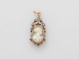 a gold and diamond cameo pendant with an image of a woman