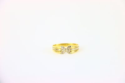 gros plan d'une bague en or sur une surface blanche