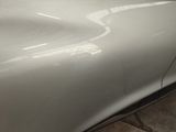 a close up of a car ' s front bumper with a dent on it