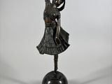 a bronze statue of a woman holding a ballerina on a black base