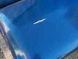 a blue seat that has a white arrow on it